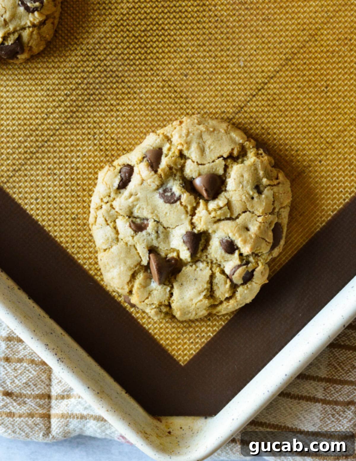 Nutty Brown Butter Chocolate Chip Cookies 16 A single brown butter chocolate chip cookie cooling on a sheet pan after baking.