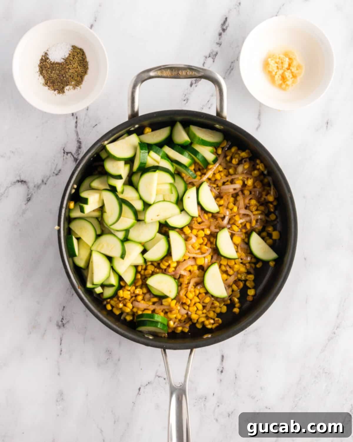 Freshly cut zucchini joining the caramelized corn and shallots in the hot skillet, ready for sautéing.