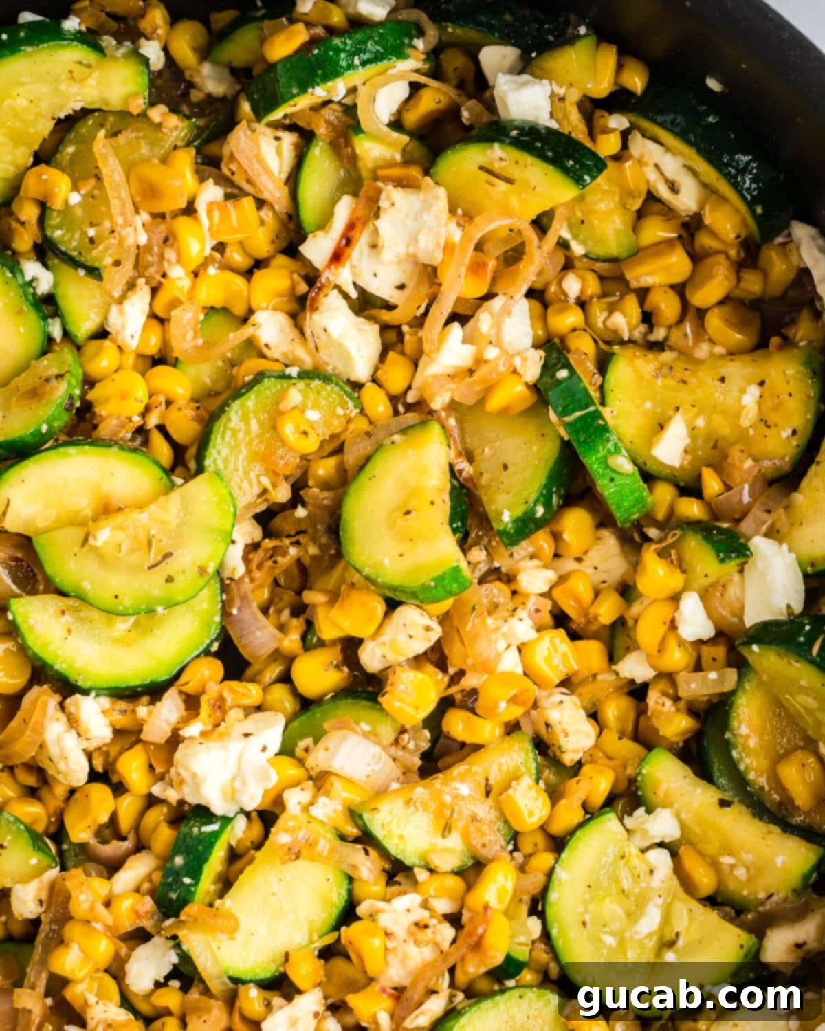 A close-up view of the vibrant sauteed zucchini and richly caramelized corn, highlighting the textures and colors.