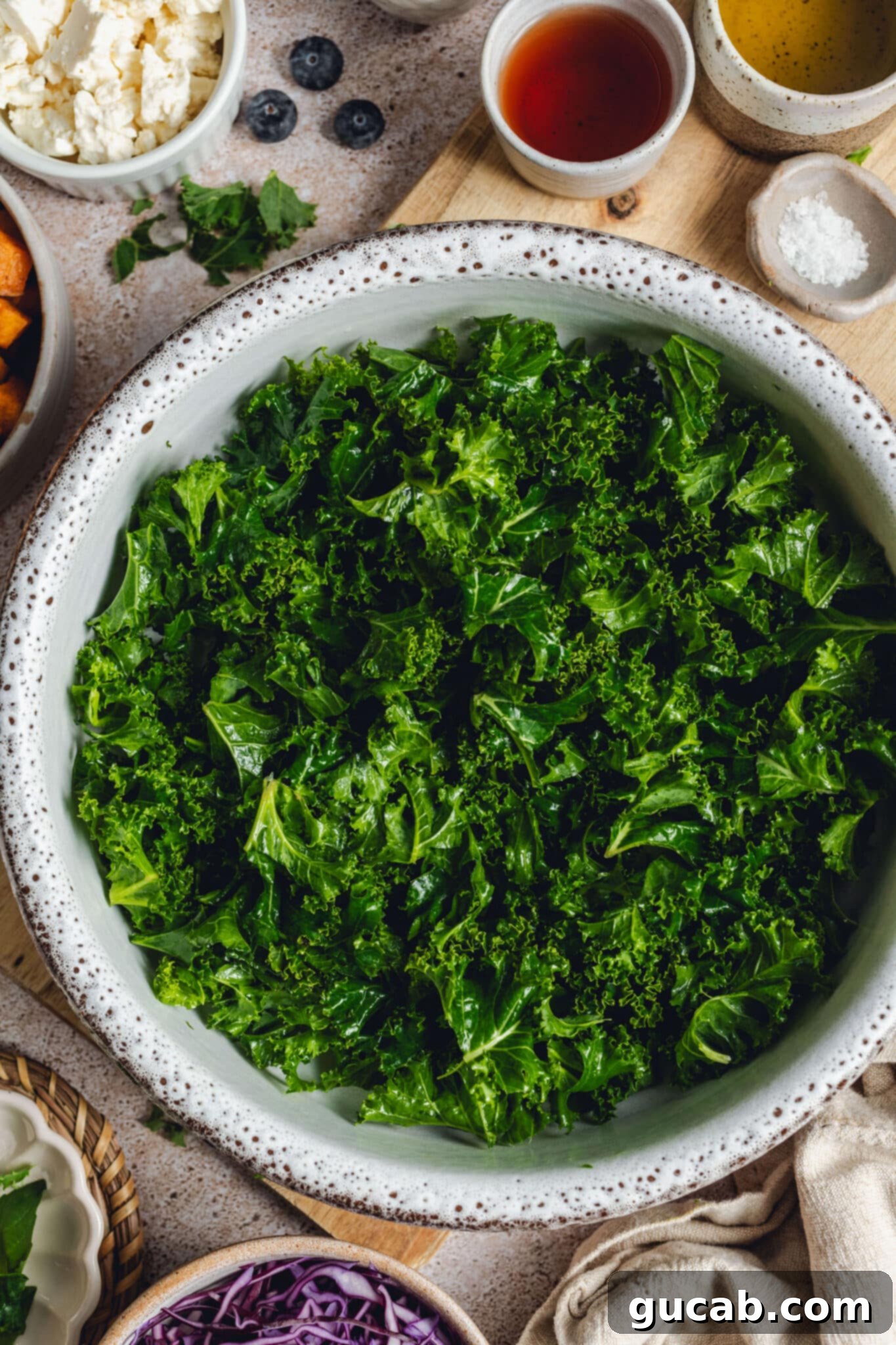 a bowl of kale leaves coated in olive oil.