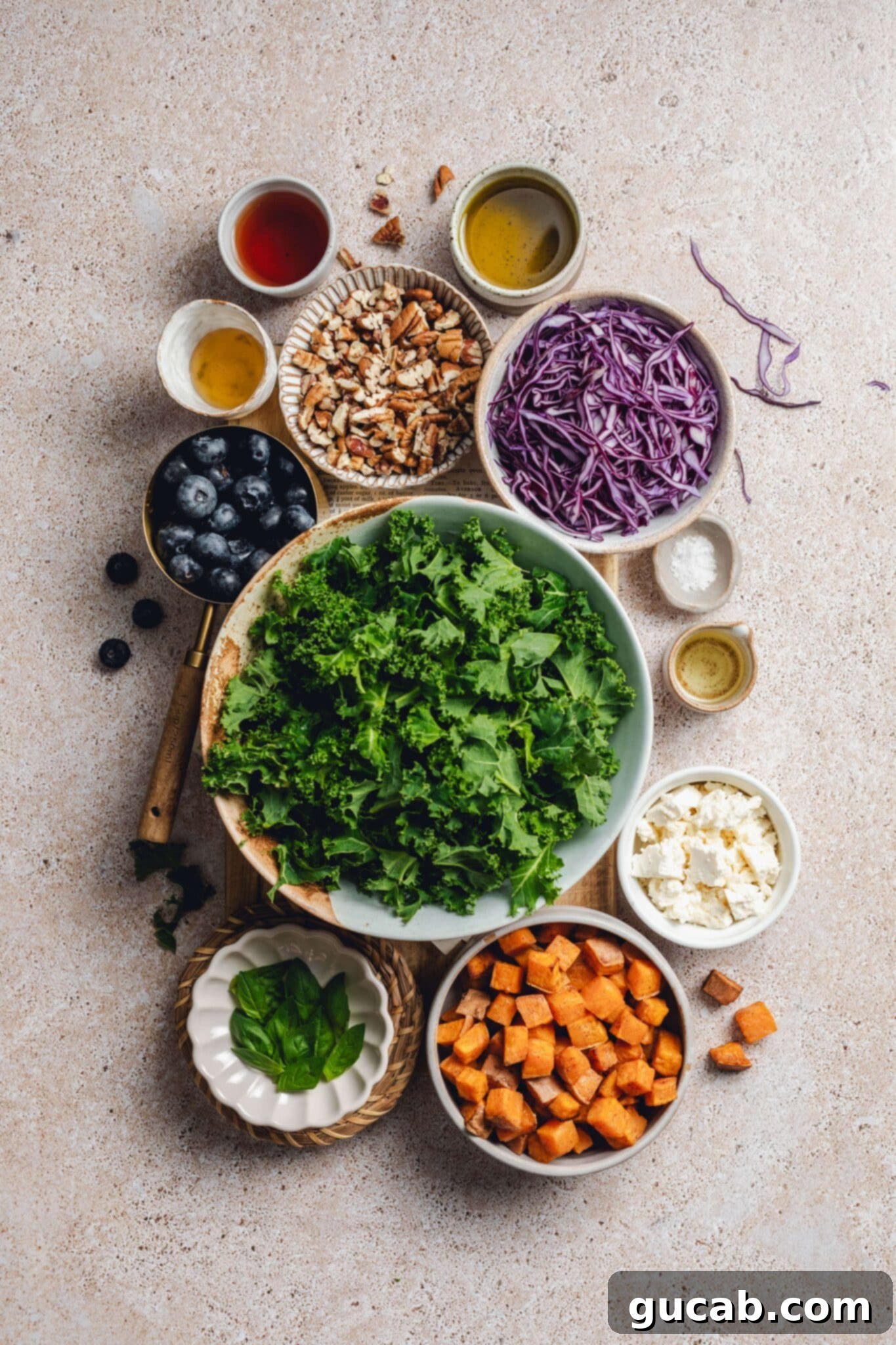 olive oil, maple syrup, pecans, cabbage, kale, blueberries, salt, feta, sweet potatoes, basil,