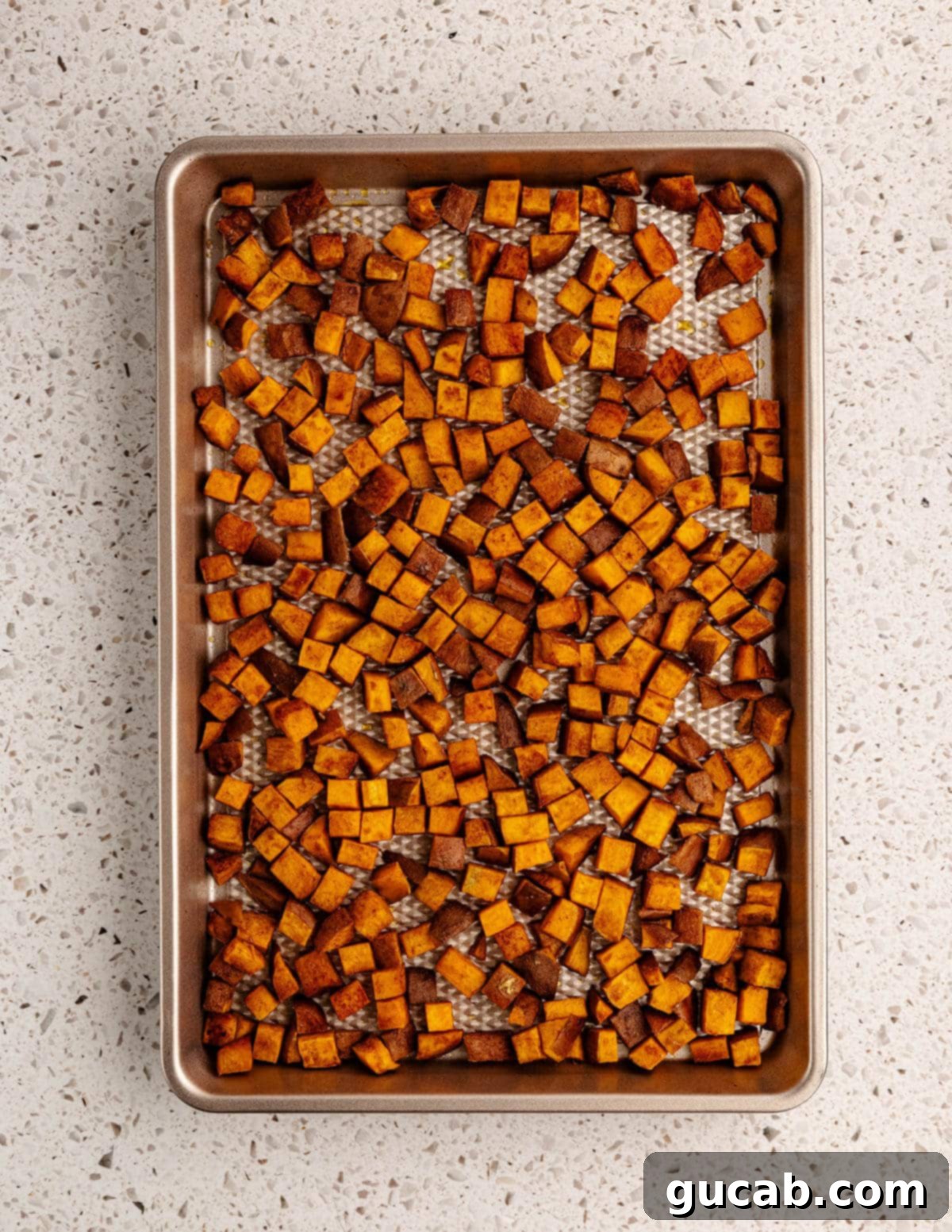 roasted sweet potatoes on a sheet pan.