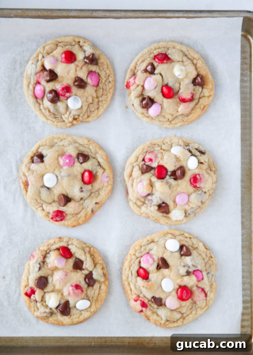 17 Heartwarming Valentine's Day Desserts 11 Valentine M&M cookies with red, white, and pink candies on a sheet pan