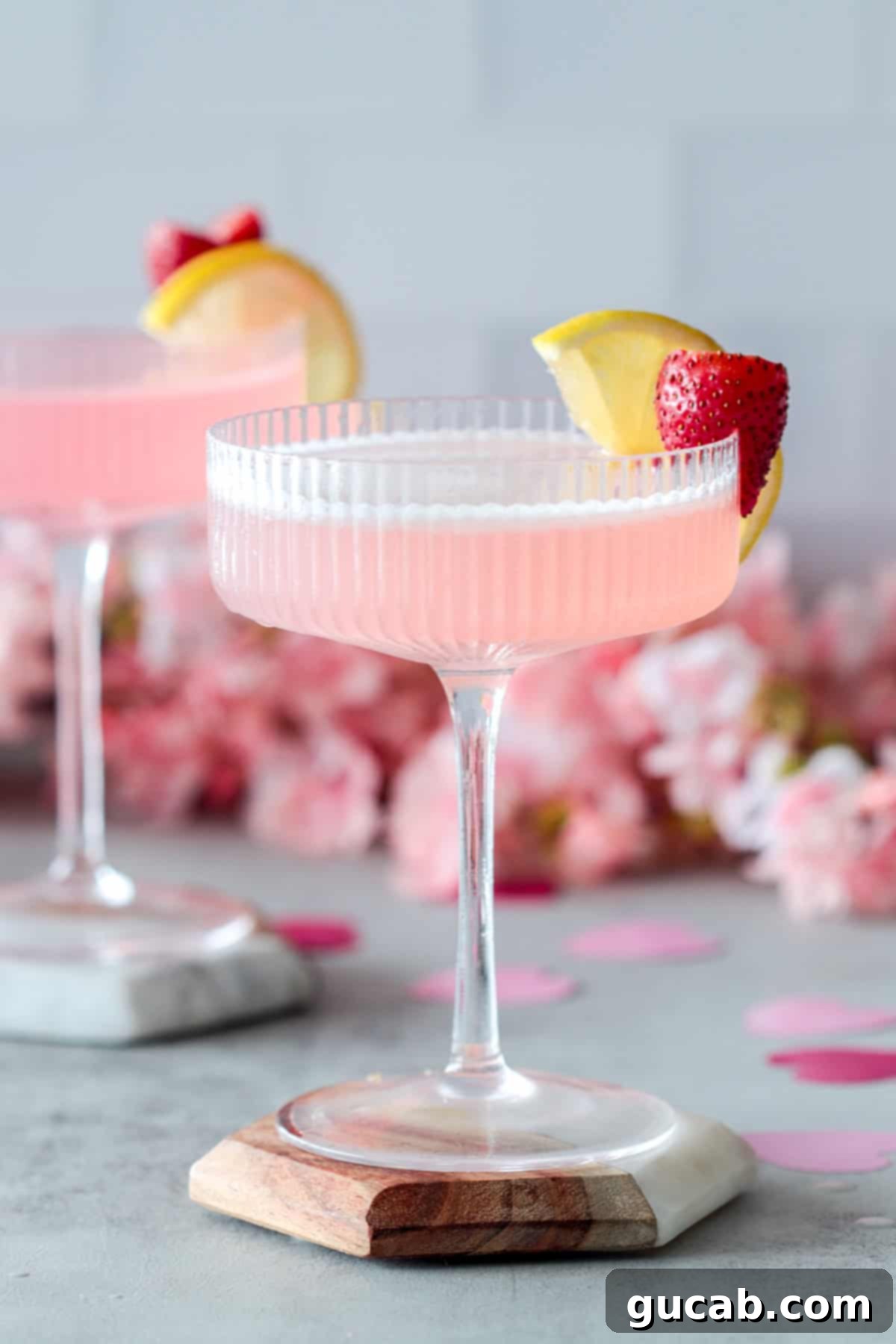 17 Heartwarming Valentine's Day Desserts 15 elegant pink cocktail with strawberry and lemon garnish, perfect for a romantic evening
