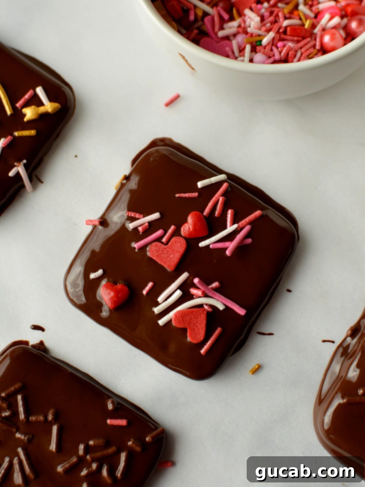 17 Heartwarming Valentine's Day Desserts 18 chocolate covered graham crackers with festive sprinkles on top, a simple Valentine's treat