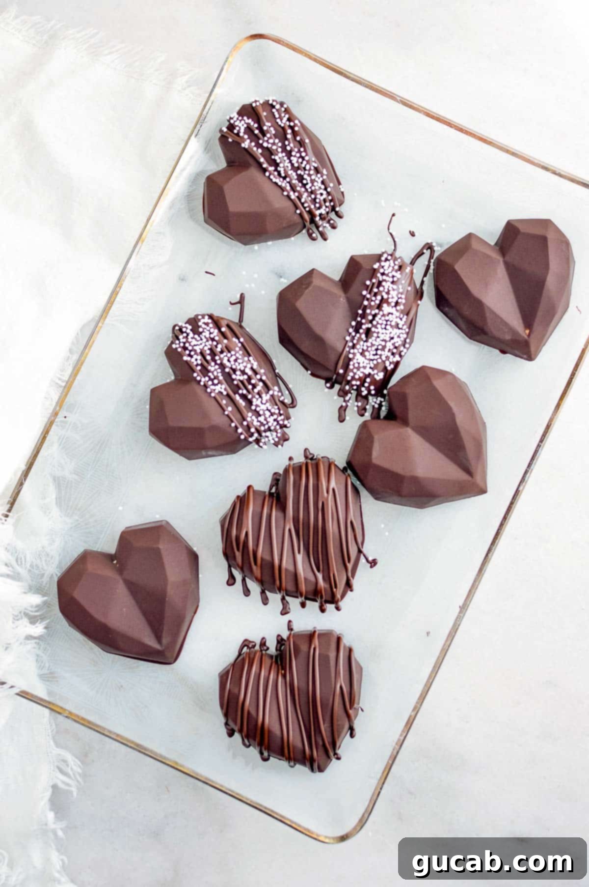 17 Heartwarming Valentine's Day Desserts 7 chocolate peanut butter hearts drizzled with chocolate, arranged on a platter