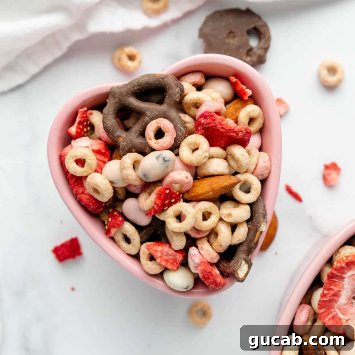 17 Heartwarming Valentine's Day Desserts 8 a heart-shaped bowl filled with homemade Valentine's trail mix, featuring dried strawberries