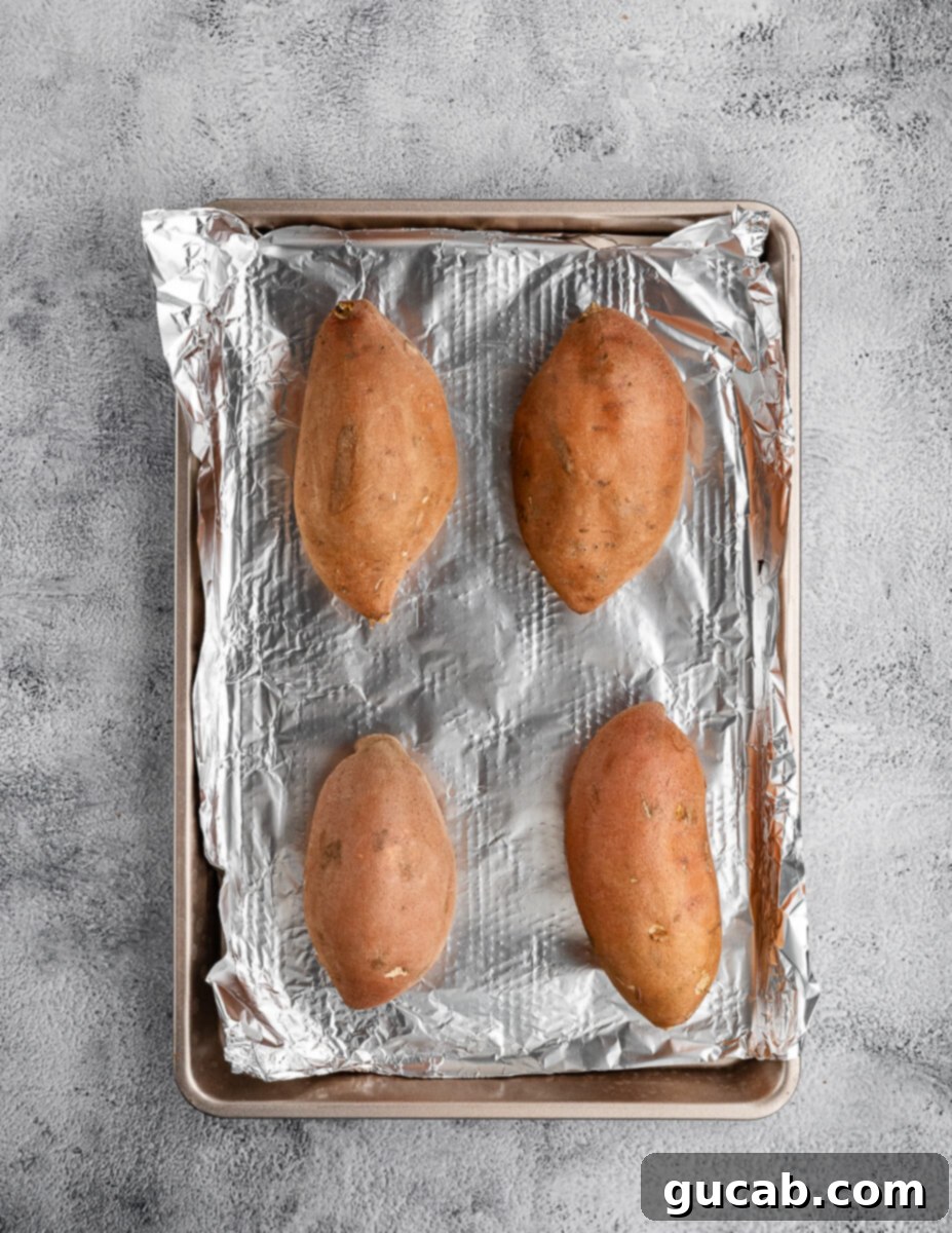 sweet potatoes on a sheet pan with aluminum foil. 
