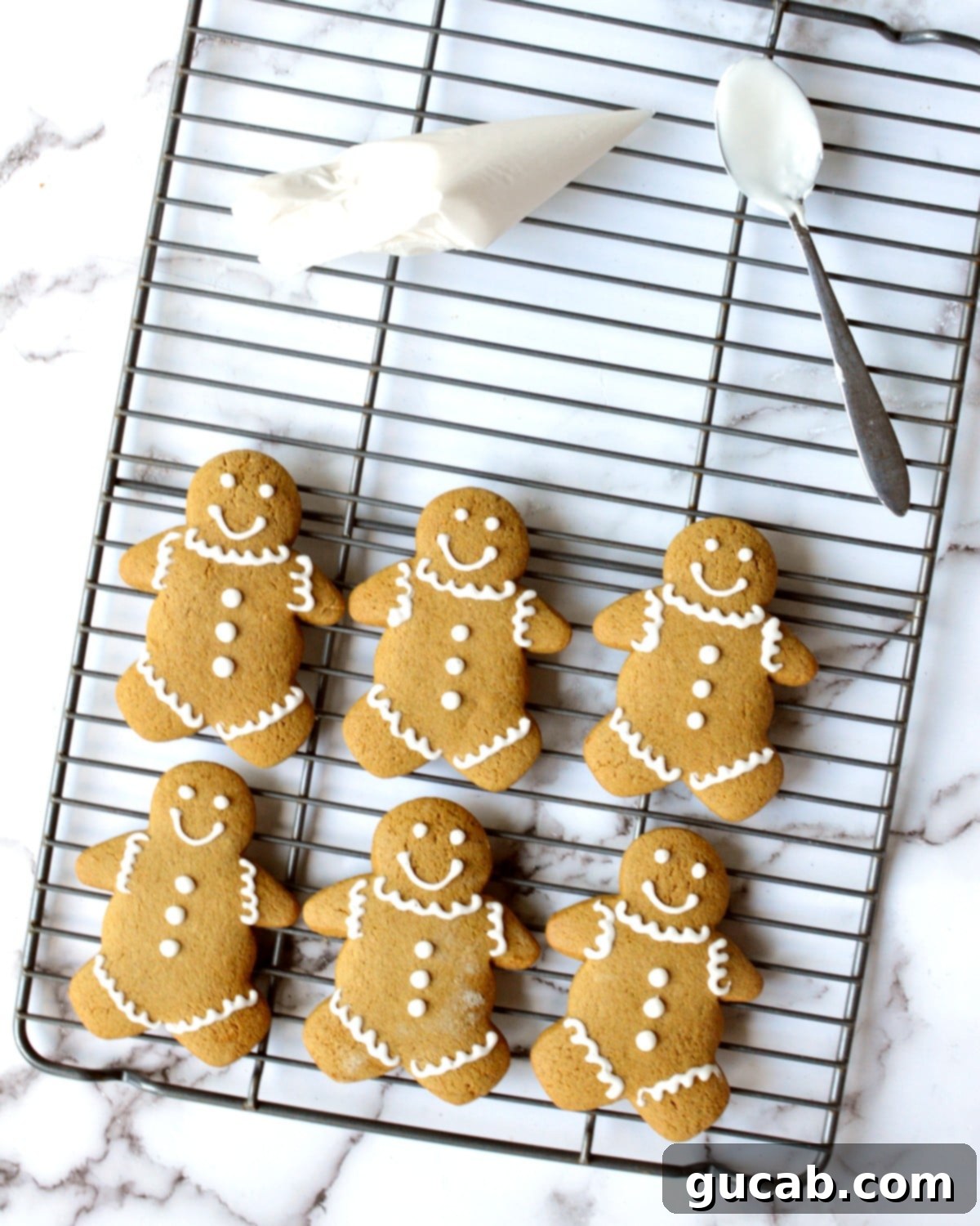Melt-in-Your-Mouth Gluten-Free Gingerbread Cookies 4 Freshly baked gluten-free gingerbread men cooling on a wire rack, ready for decoration.