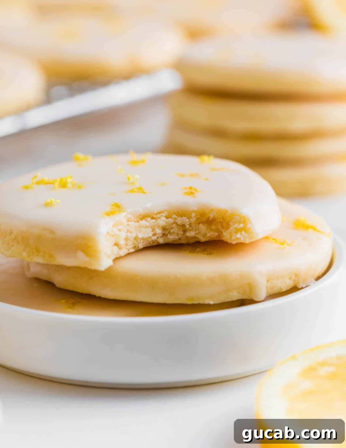 Sweet and Zesty Lemon Cookies 13 close up of a glazed sugar cookie with a bite out of it.