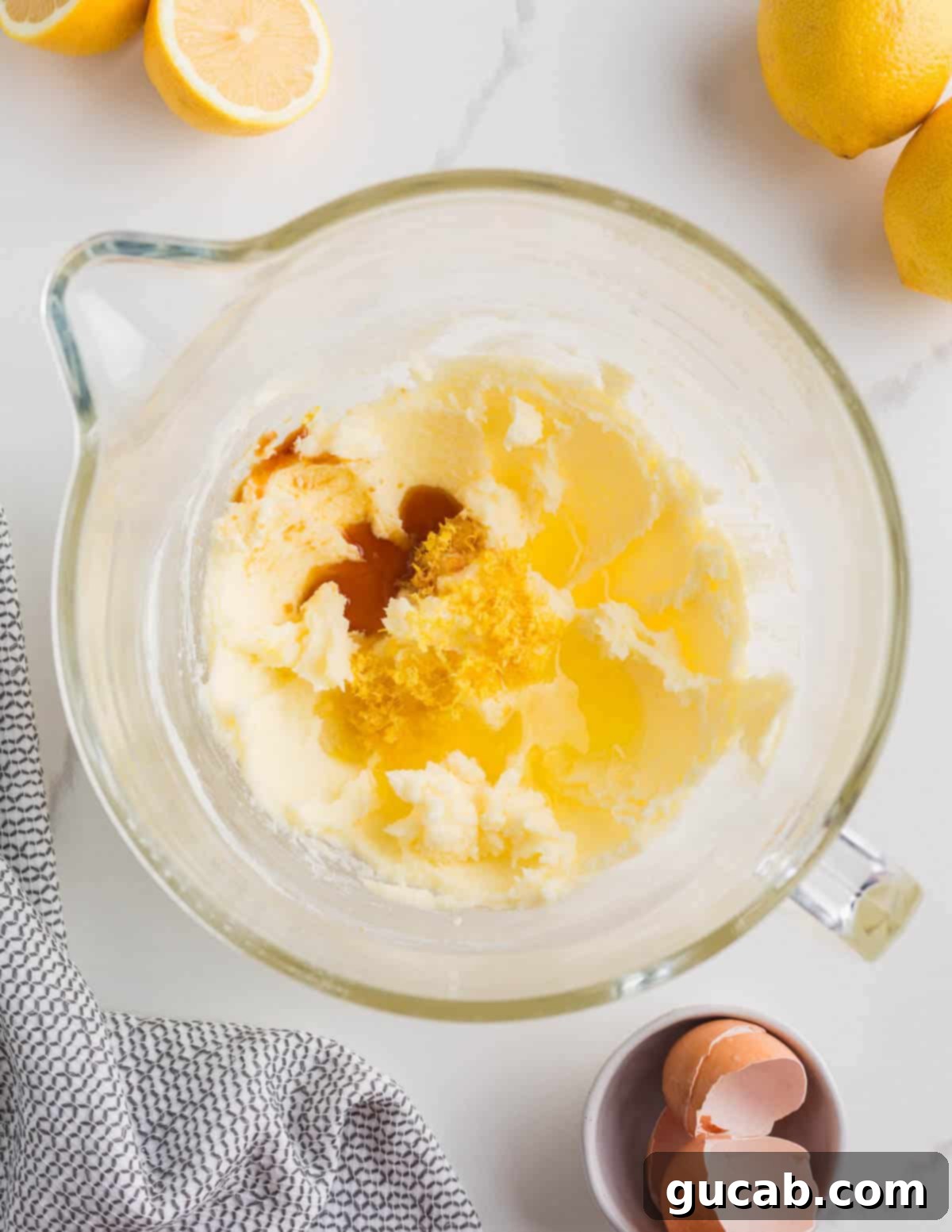 Sweet and Zesty Lemon Cookies 6 a bowl of creamed butter and sugar with vanilla and lemon juice on top.