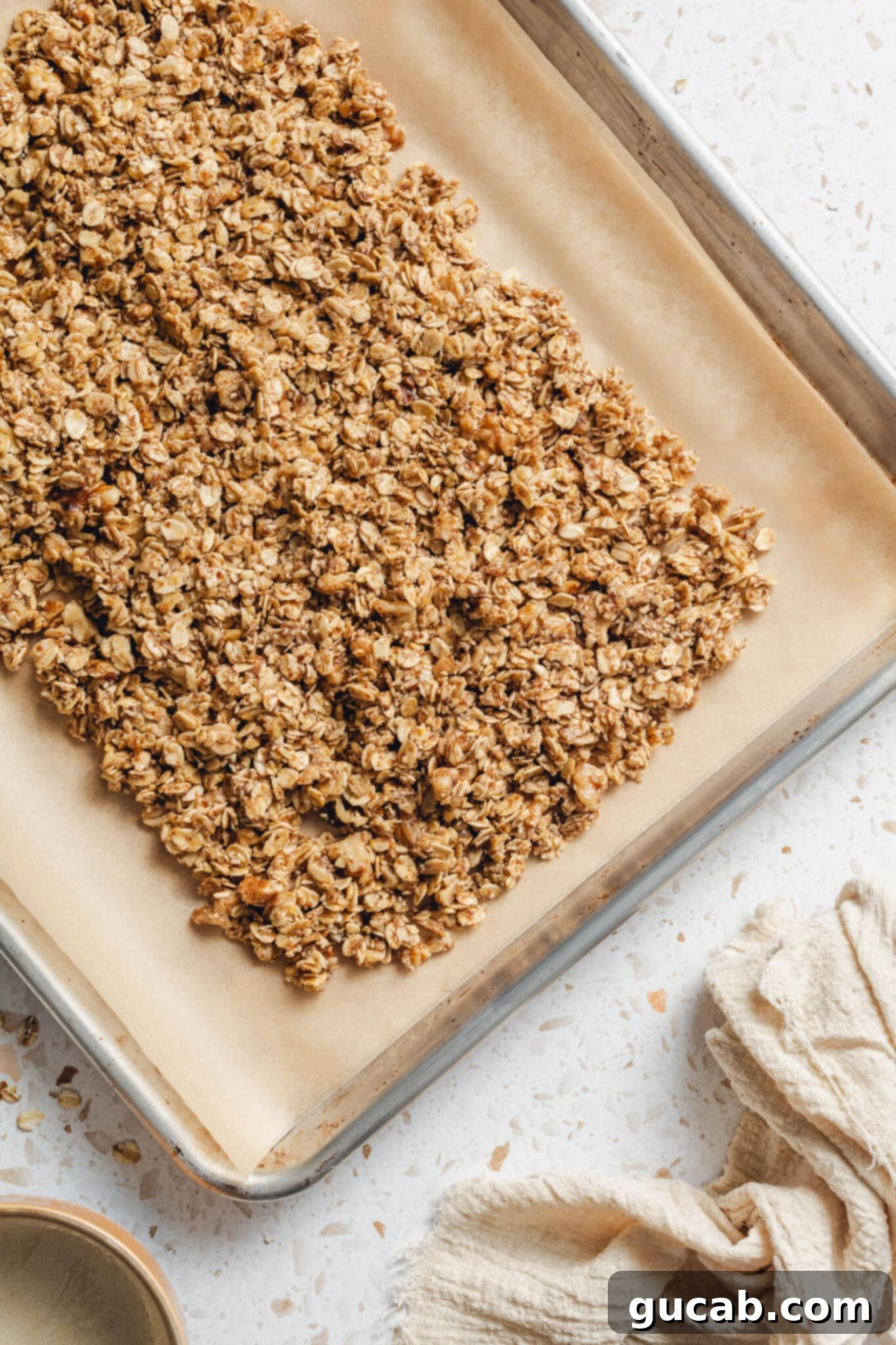 wet oat mixture on a sheet pan with parchment paper. 