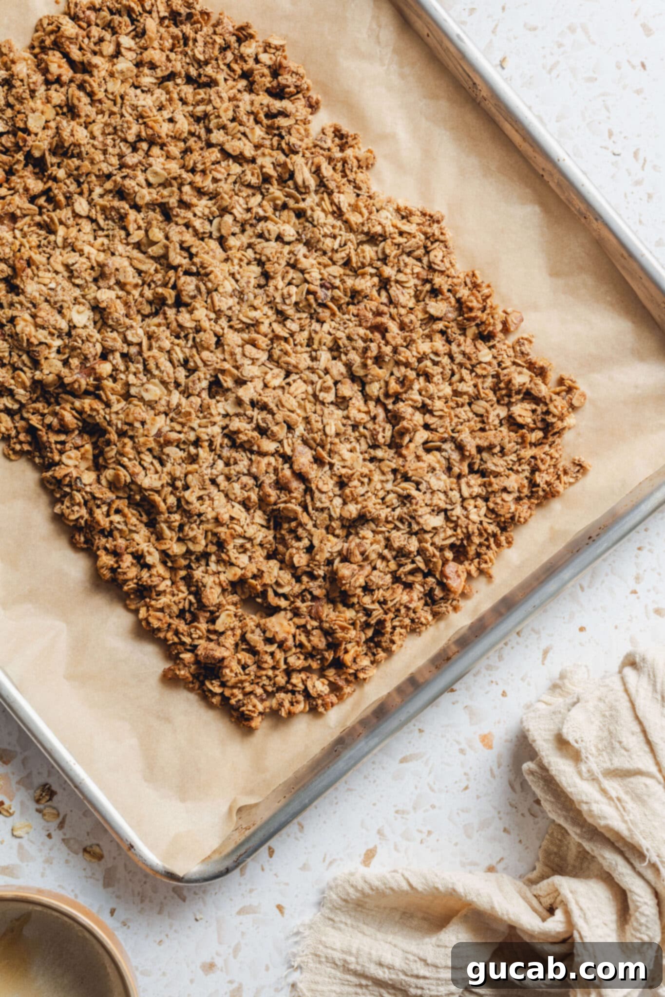 baked oat mixture on a sheet pan with parchment paper. 