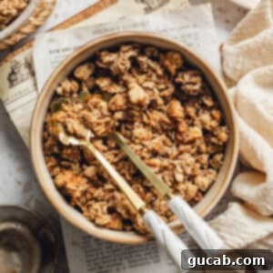 a bowl of maple walnut granola with spoons in it.