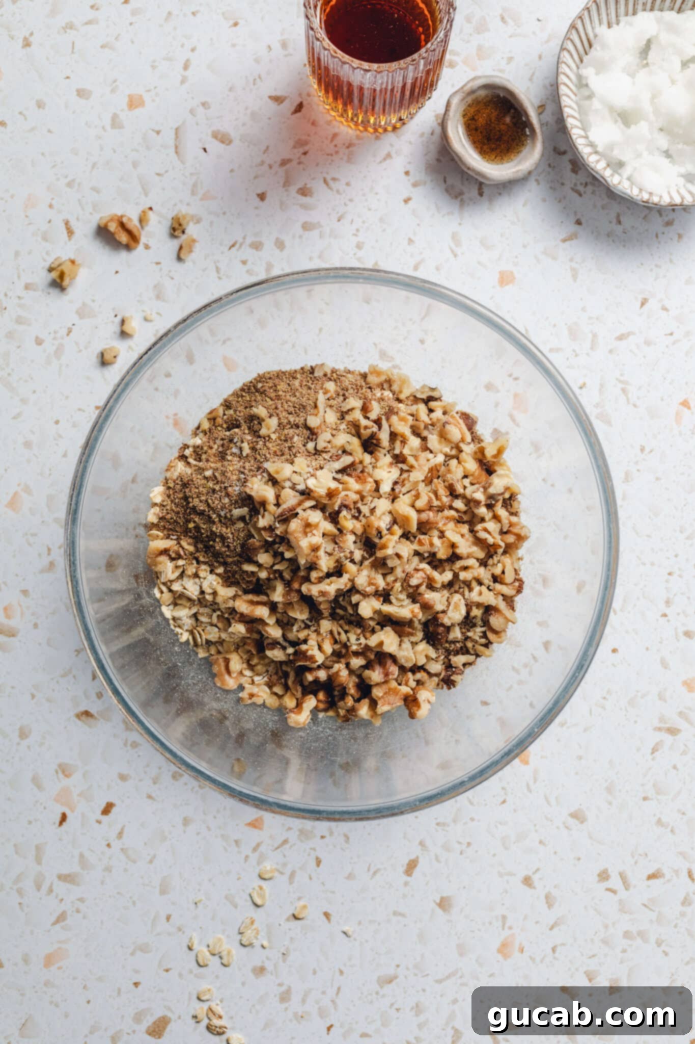a bowl of walnuts, oats, flax meal, cinnamon, and salt. 