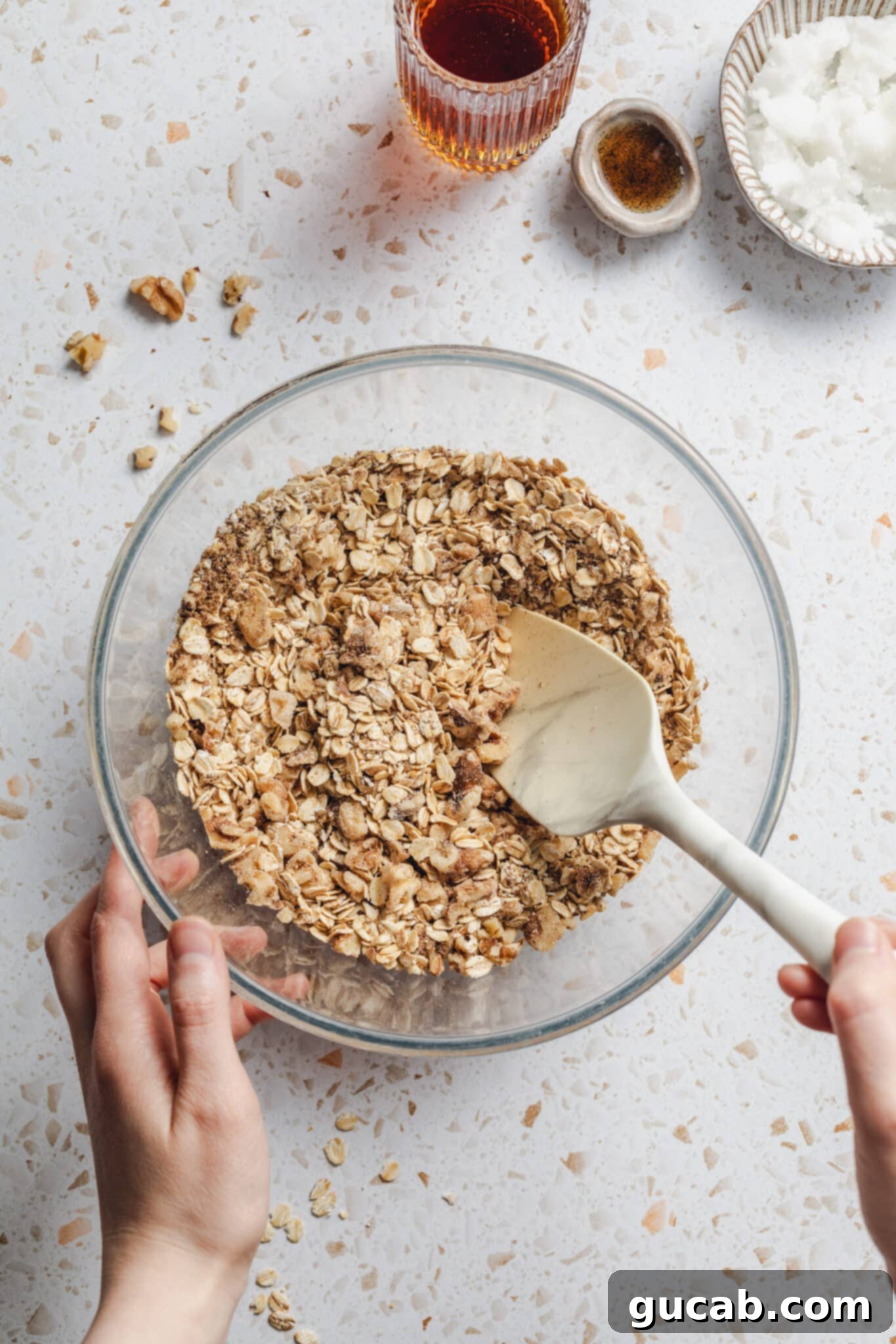 stirring a bowl of oats, walnuts, and flax meal. 