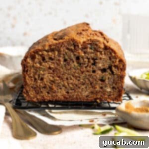 A freshly baked loaf of gluten-free zucchini bread cooling on a wire rack, ready to be sliced and served.