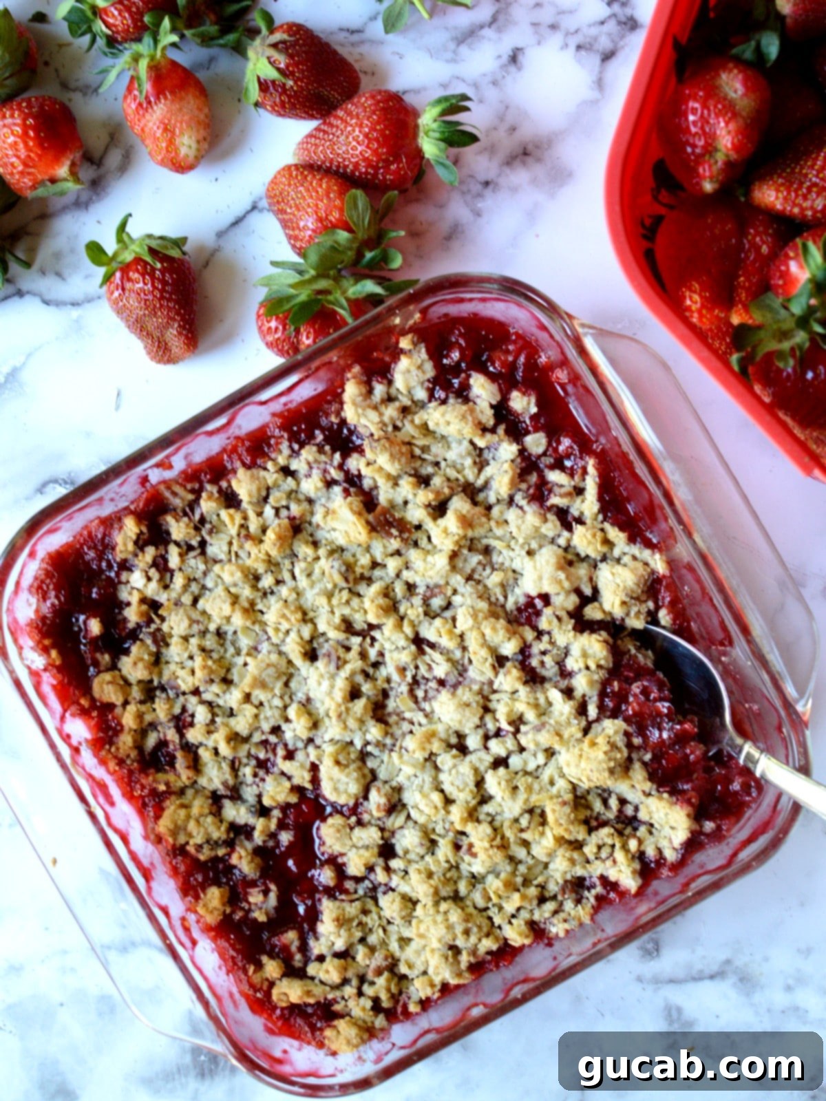 Irresistible Gluten Free Strawberry Crisp 2 A gluten free strawberry crisp next to fresh strawberries