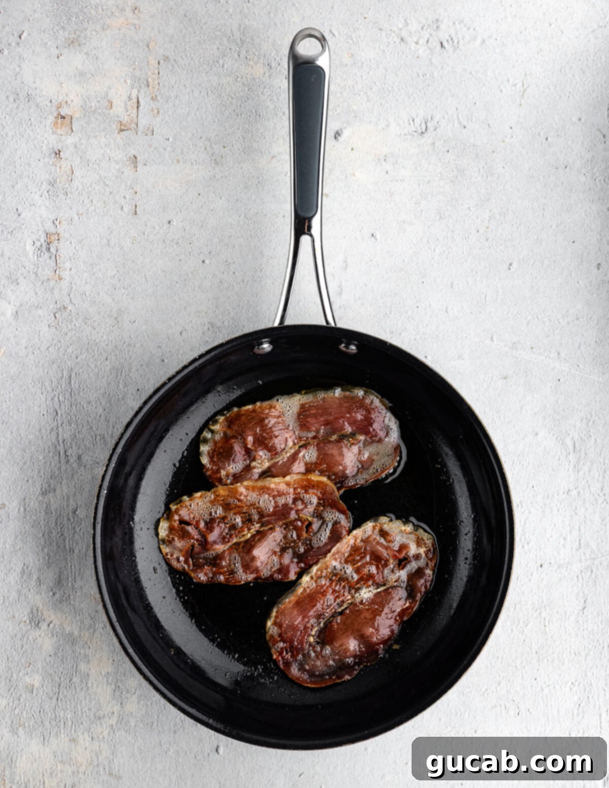 Savory Prosciutto & Cheese Scramble 6 Pan-fried prosciutto slices turning golden and crispy in a nonstick skillet.