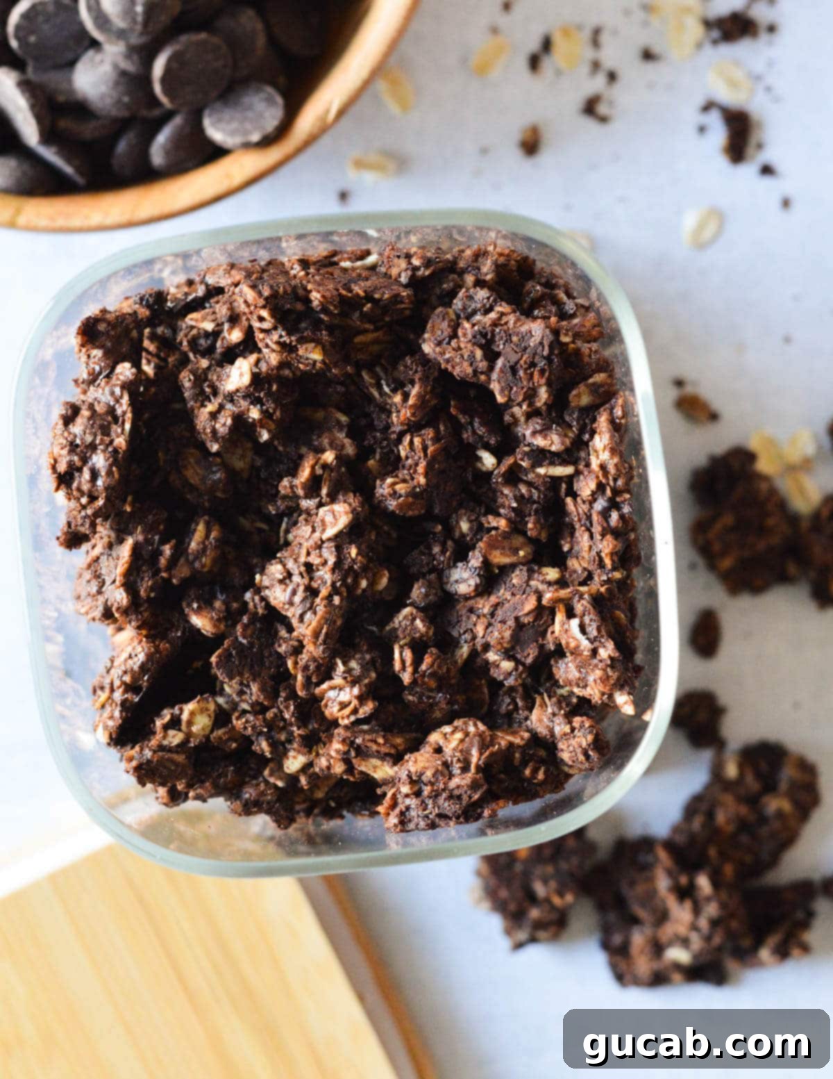 Dark Chocolate Granola 17 Beautiful dark chocolate granola clusters stored in an elegant glass storage dish on a kitchen counter, ready for easy access.