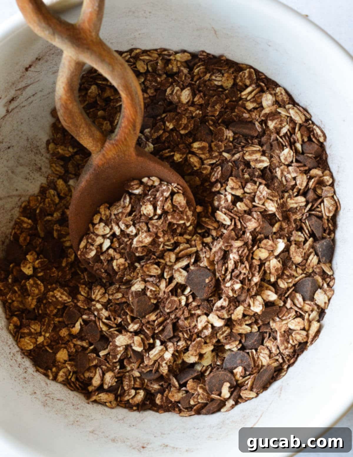 Dark Chocolate Granola 8 The dry oat and cocoa mixture in a large bowl, showing a consistent blend of ingredients before wet ingredients are added.