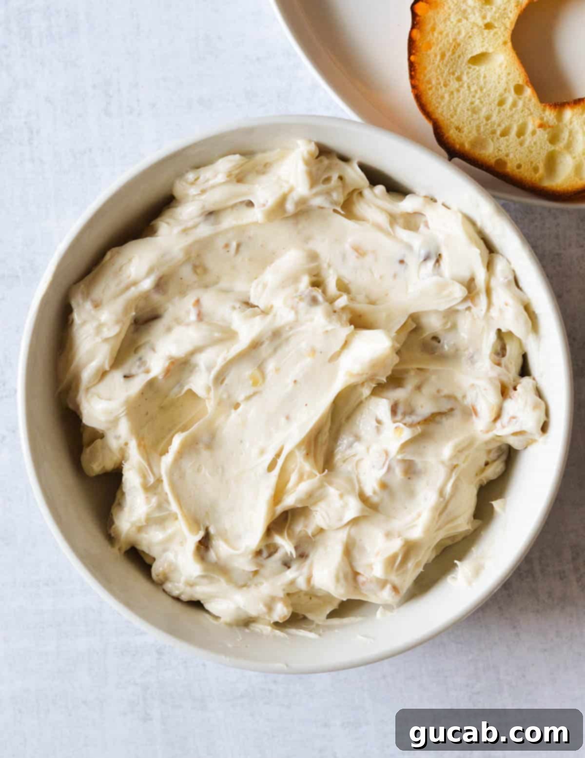 A decorative bowl filled with the delectable honey walnut cream cheese, ready to be served or stored.