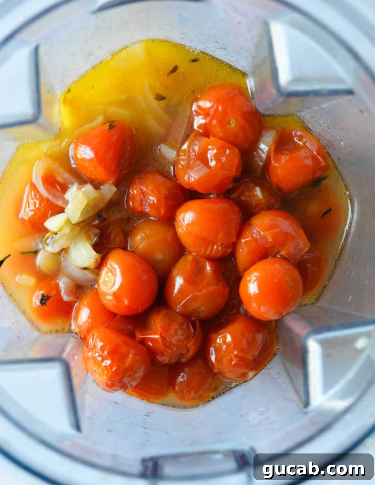 Cherry Tomato Soup 8 Roasted cherry tomatoes and vegetable stock in a high-speed blender, ready to be blended into a smooth base.