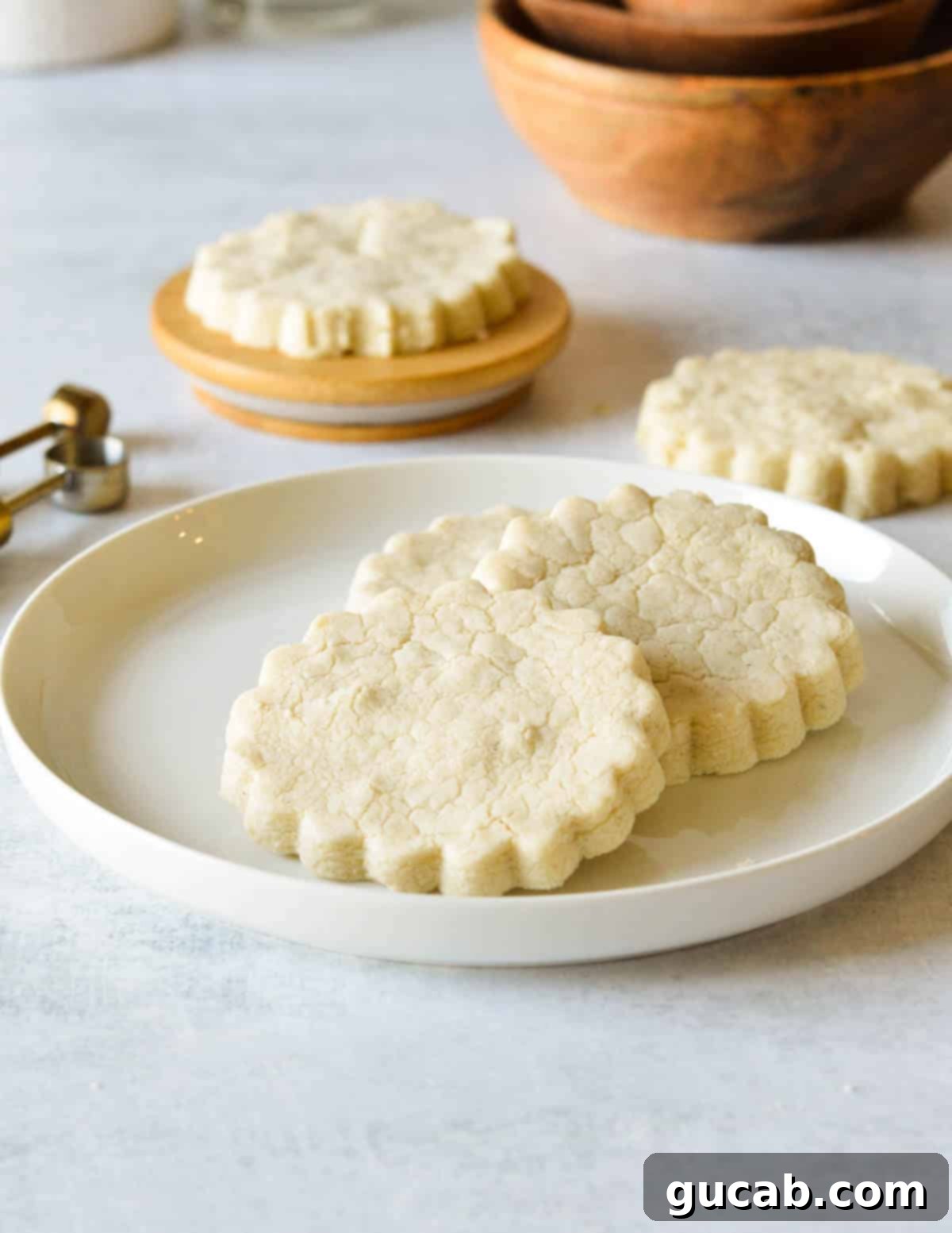 Buttery Gluten-Free Shortbread 13 a plate with three gluten free shortbread cookies on it.