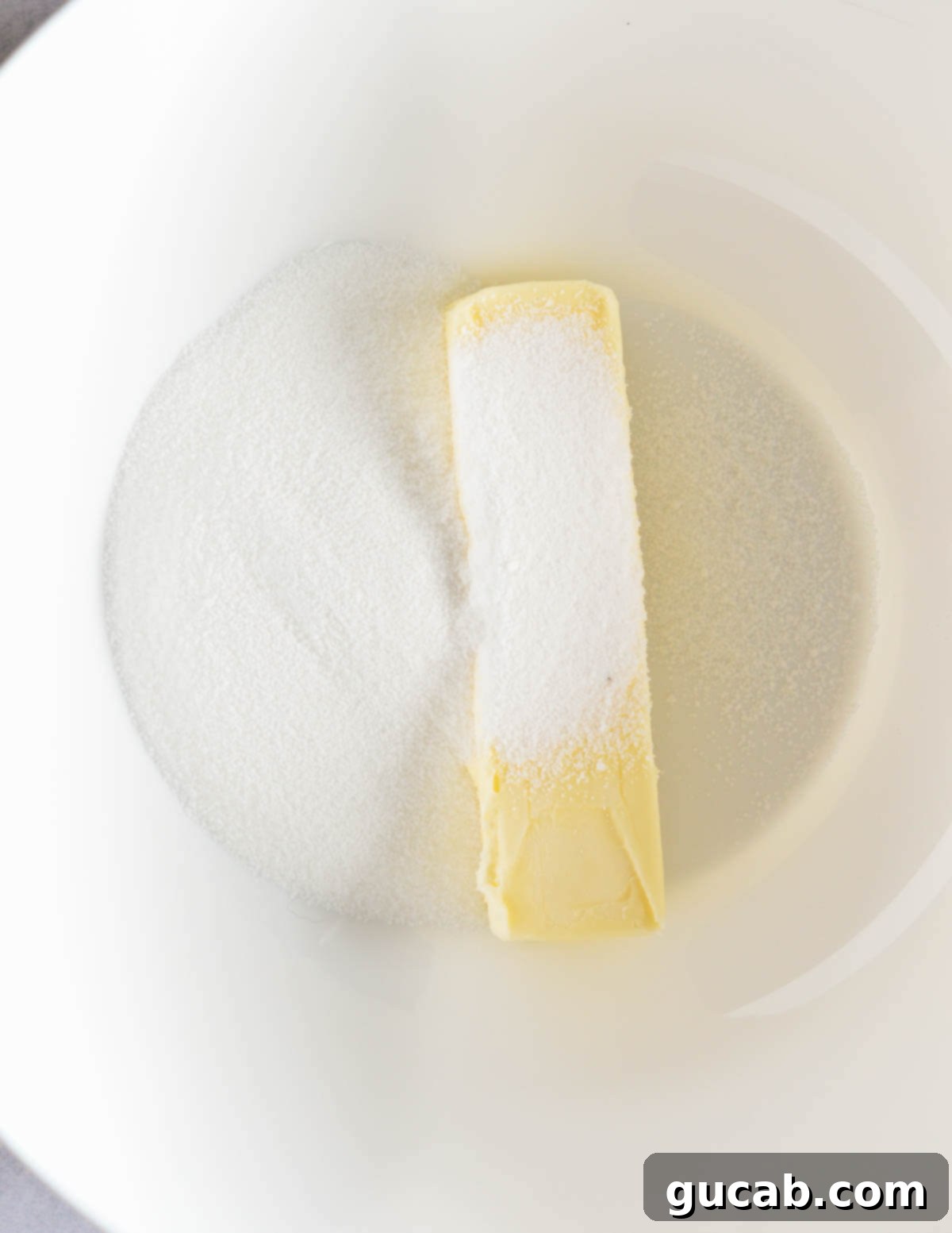 Buttery Gluten-Free Shortbread 4 a stick of butter and sugar in a bowl.