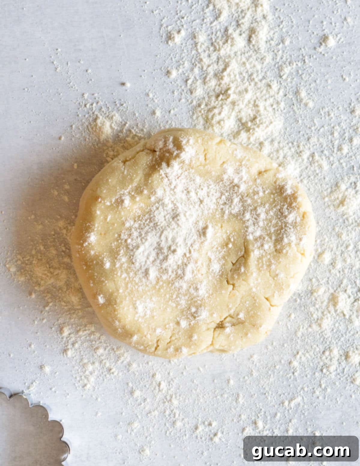 Buttery Gluten-Free Shortbread 8 a round disc of gluten-free shortbread dough on a workspace with gluten-free flour