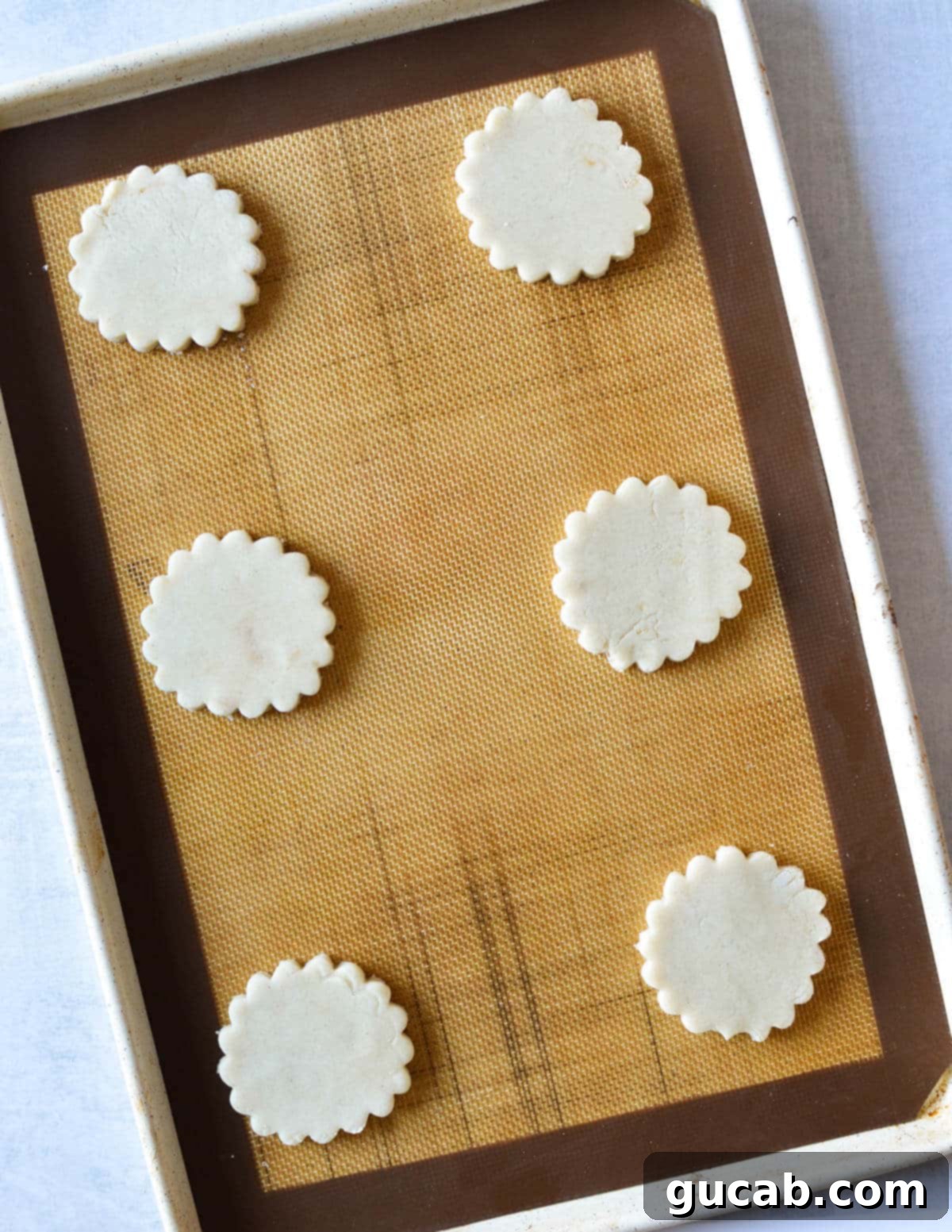 Buttery Gluten-Free Shortbread 10 unbaked gluten free shortbread cookies on a sheet pan.