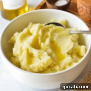 A bowl of creamy olive oil mashed potatoes, ready to be served. Top-down view.