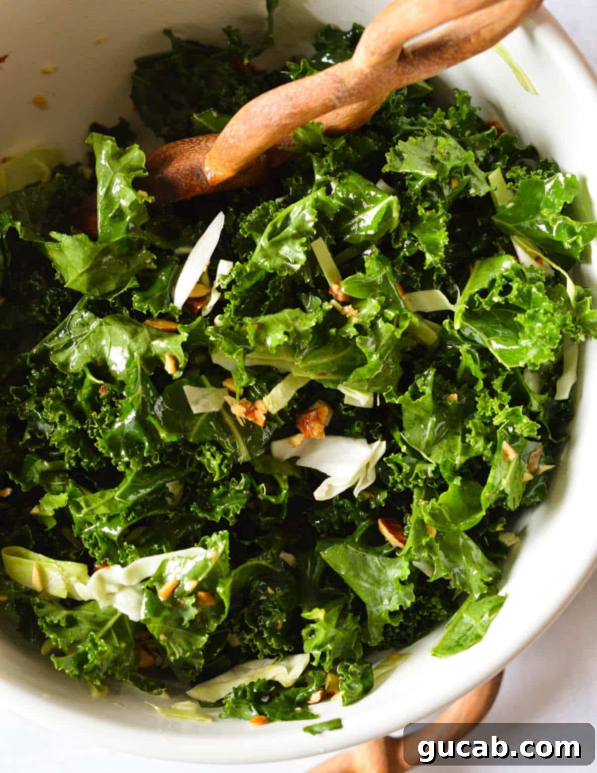 Kale Crunch Salad 13 close up of a kale salad with chopped almonds and green cabbage.