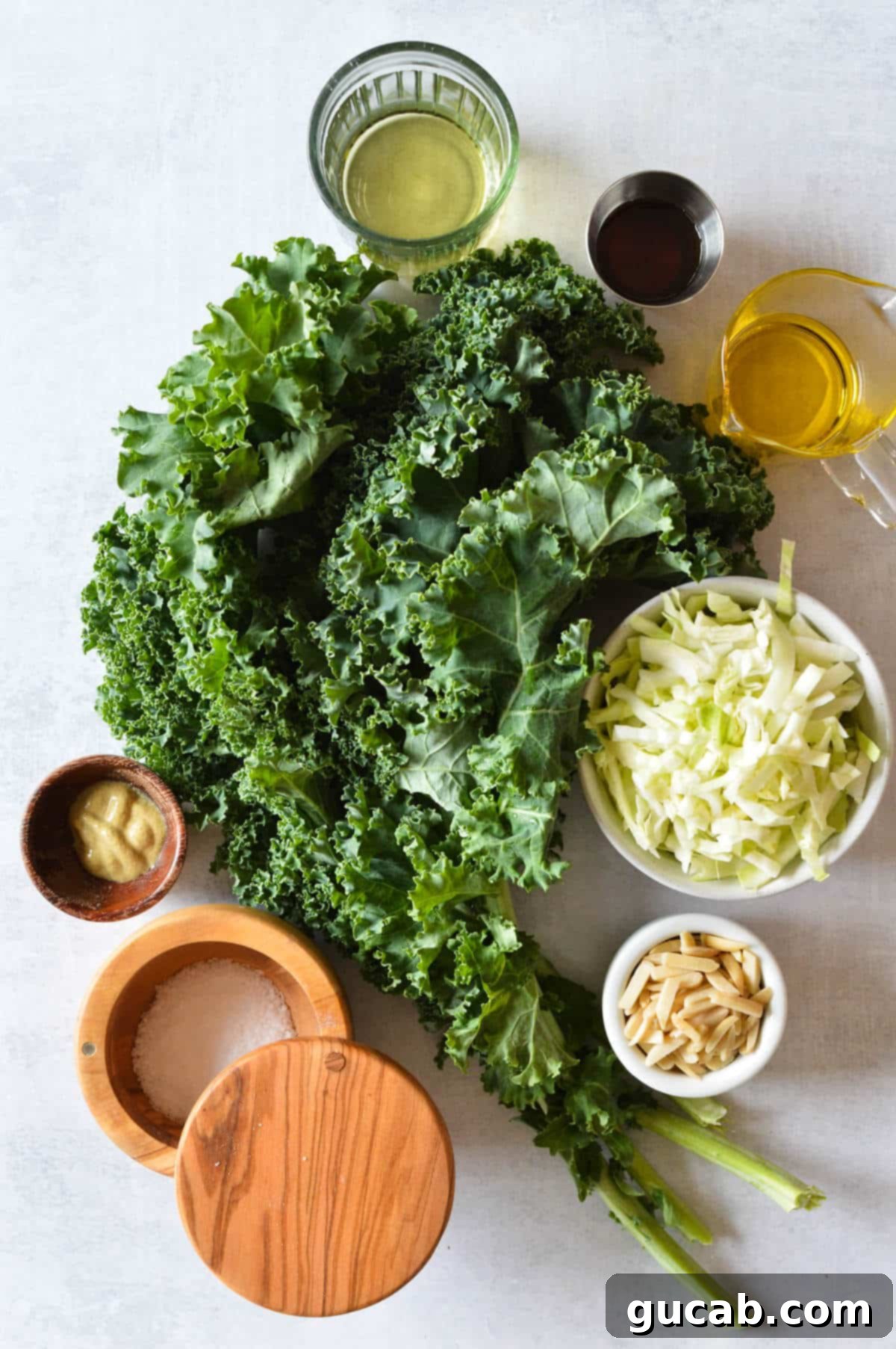 Kale Crunch Salad 3 bunch of kale, shredded cabbage, maple syrup, olive oil, white wine vinegar, dijon mustard, kosher salt, almonds.