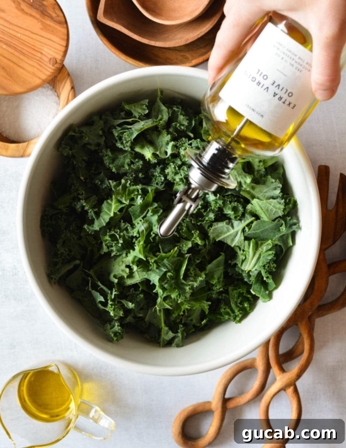 Kale Crunch Salad 5 drizzling olive oil onto kale leaves.