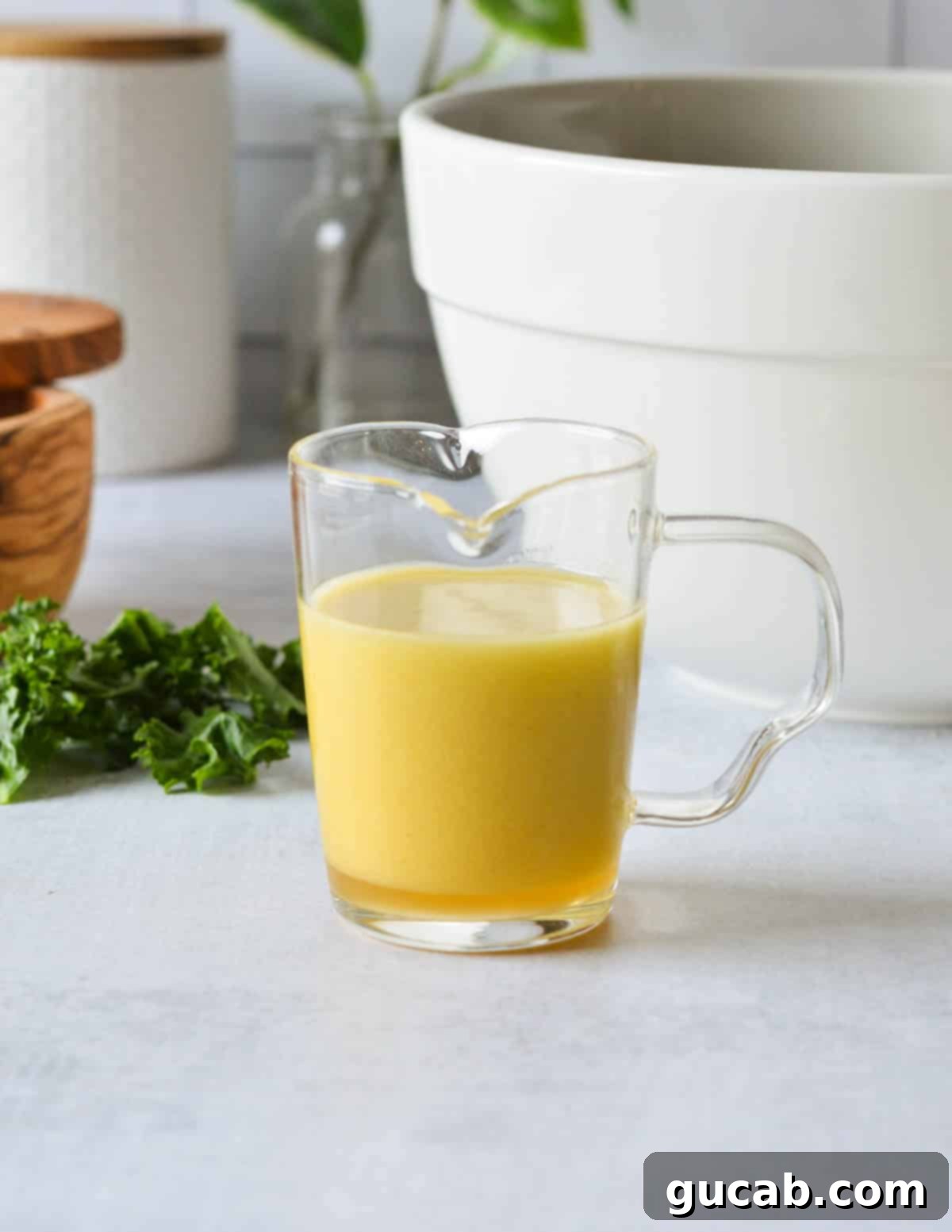 Kale Crunch Salad 10 apple maple vinaigrette in a glass cup.