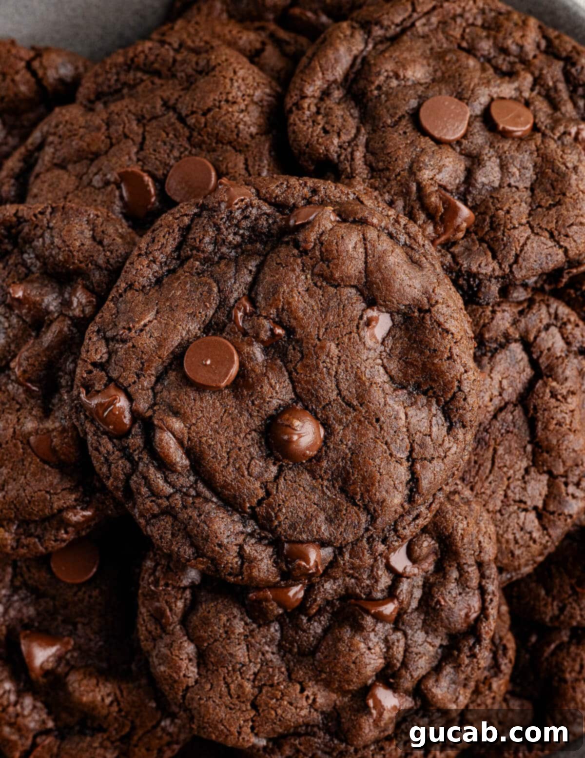 A perfectly baked stack of dark chocolate cookies, highlighting their soft texture and rich color.