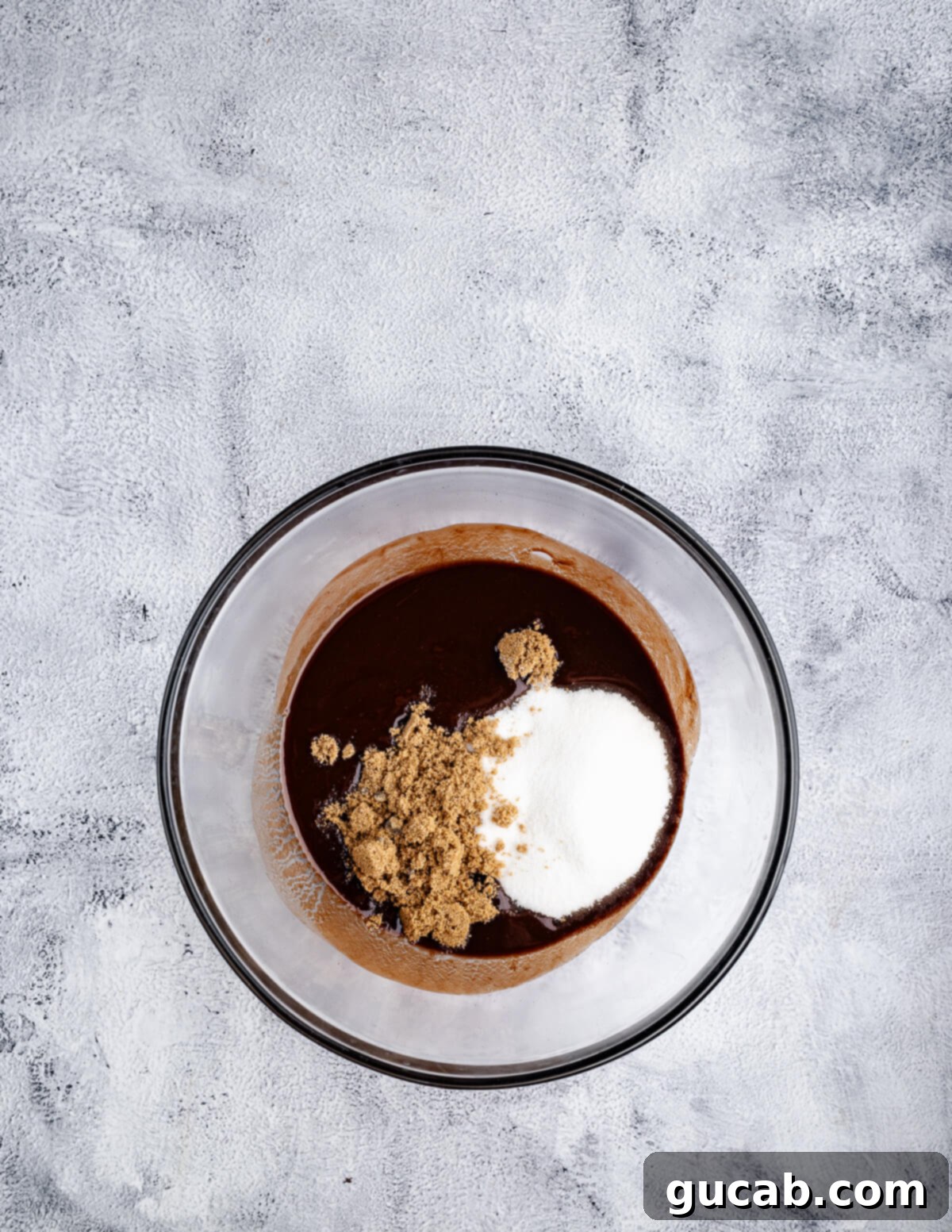Dark brown sugar and granulated sugar added to the melted chocolate and butter mixture.