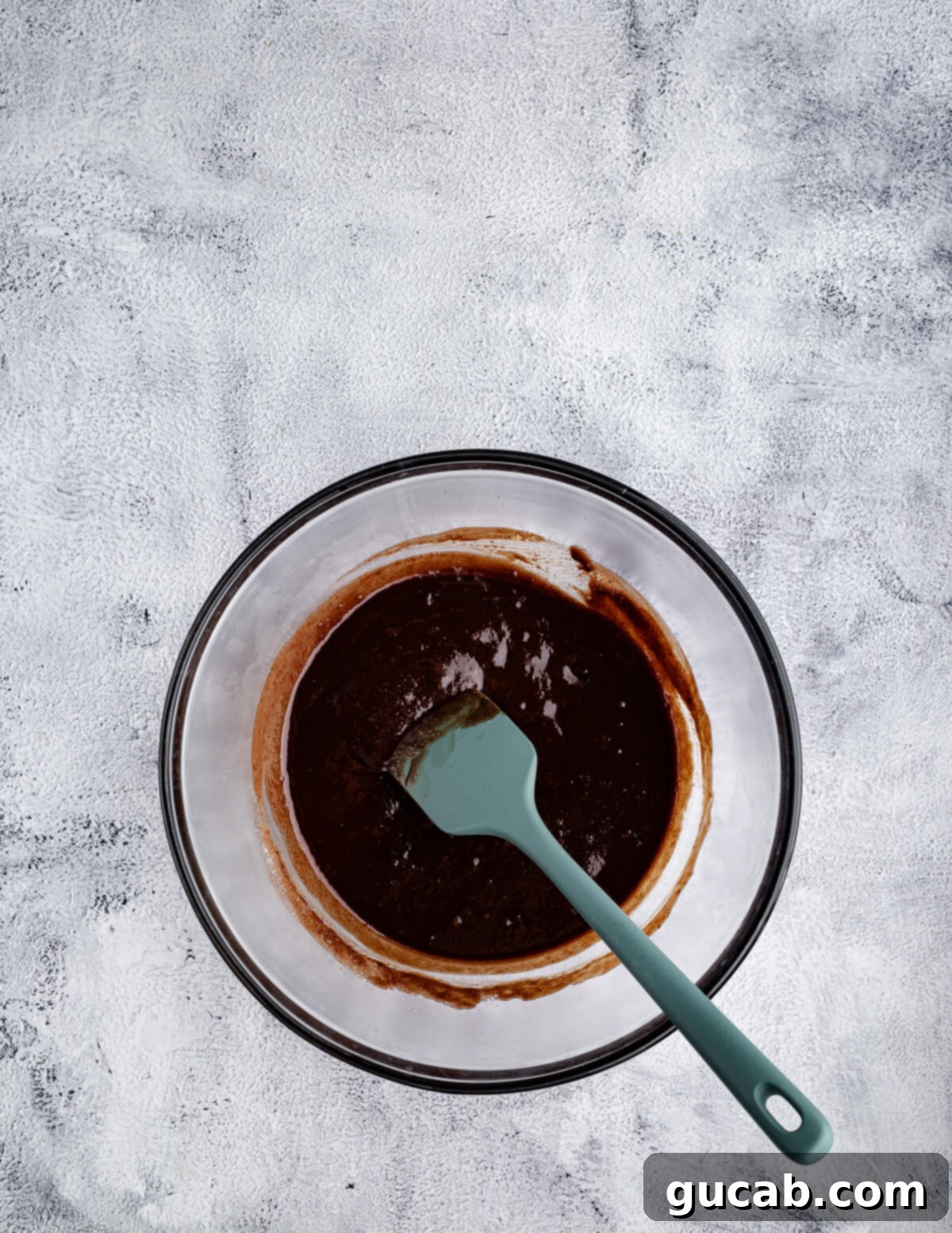 The chocolate, butter, and sugar mixture thoroughly combined with a spatula.