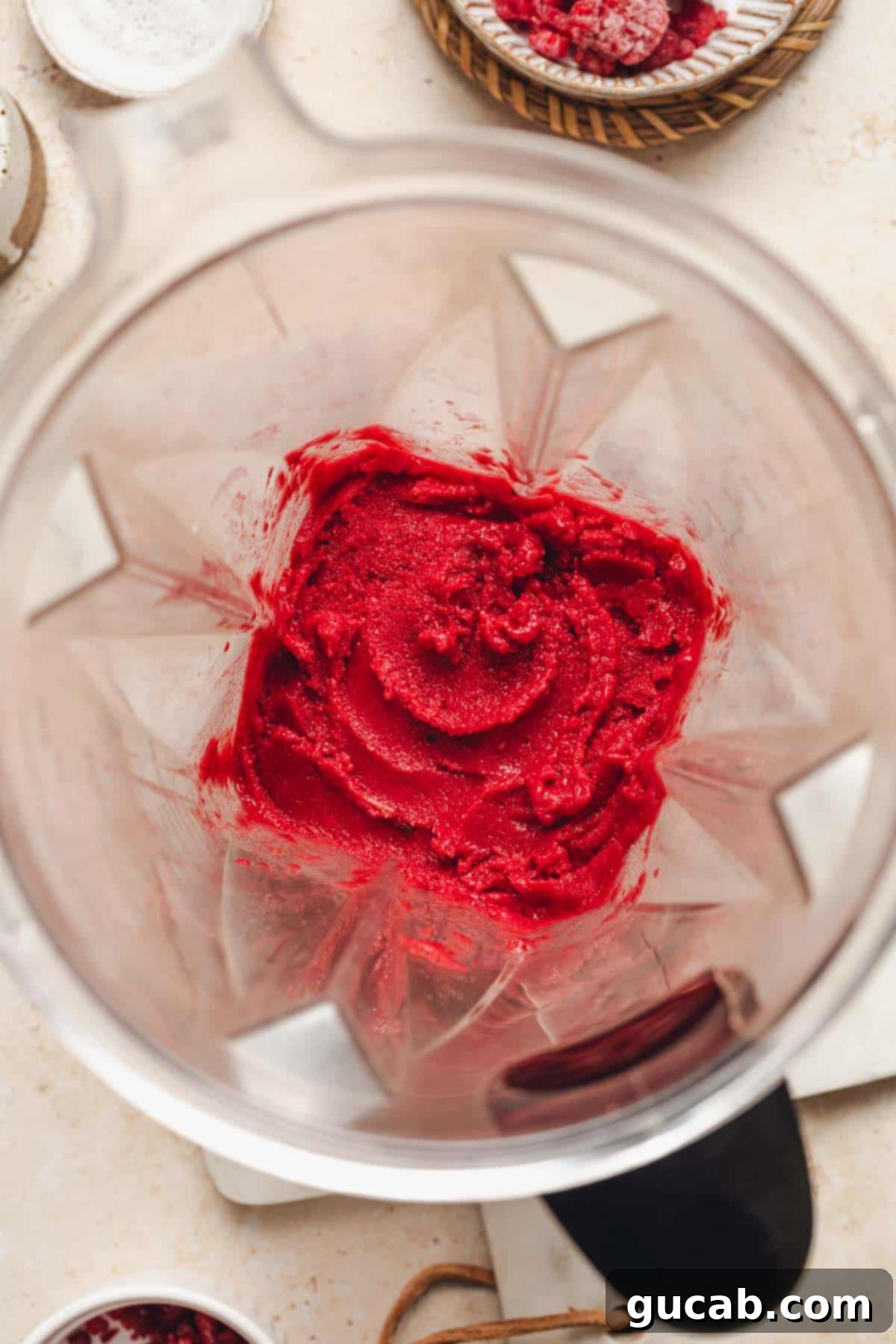 Smooth and perfectly blended raspberry sorbet ready in the blender pitcher.