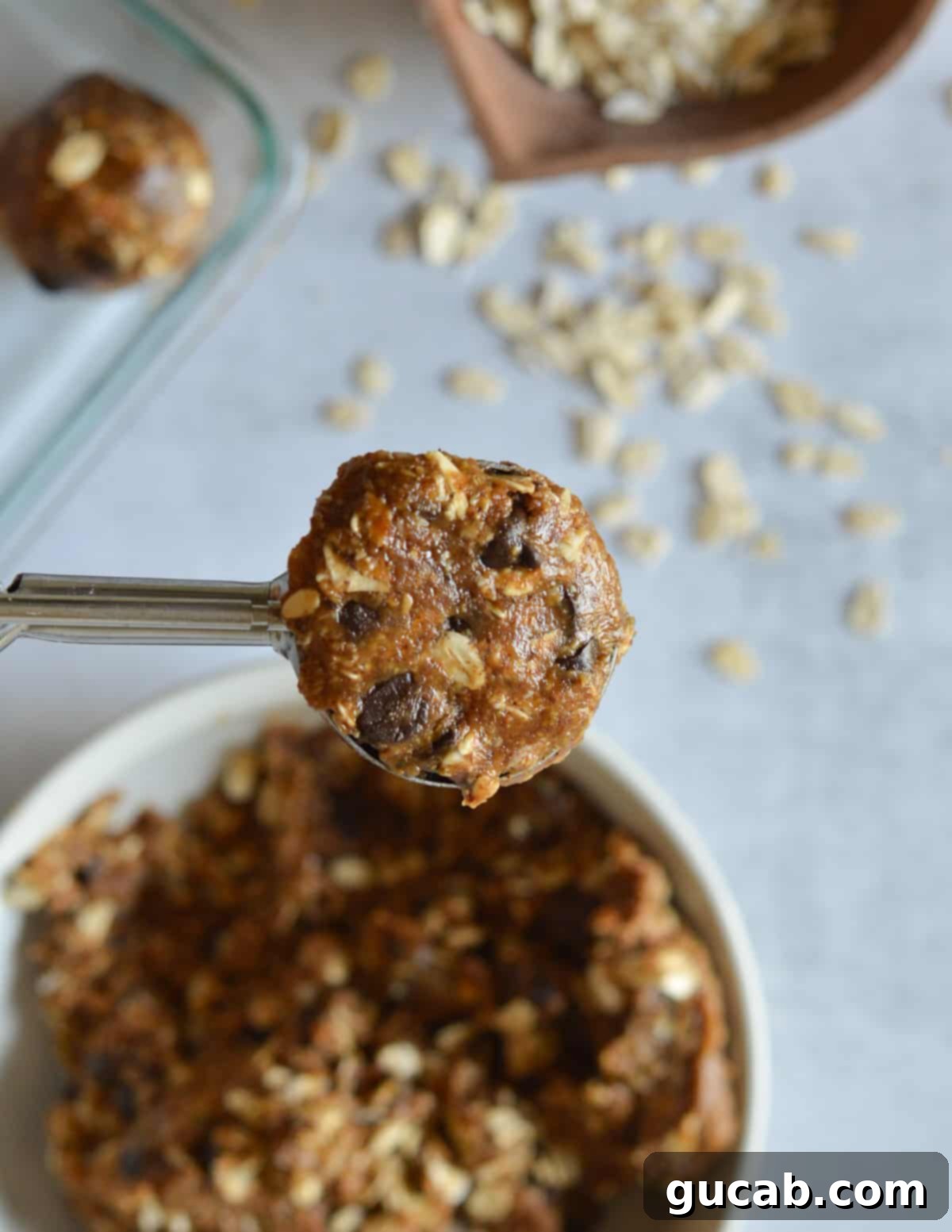 an almond butter energy ball in a portion scoop. 