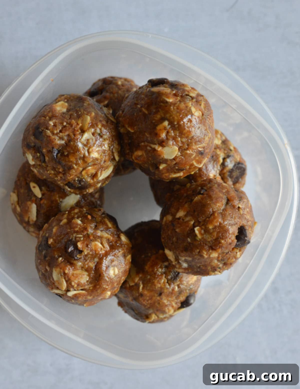 a container with almond butter protein balls in it. 