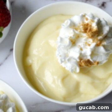 Creamy Gluten-Free Vanilla Pudding 4 A close-up shot of creamy gluten-free vanilla pudding in a glass dish, inviting and delicious.