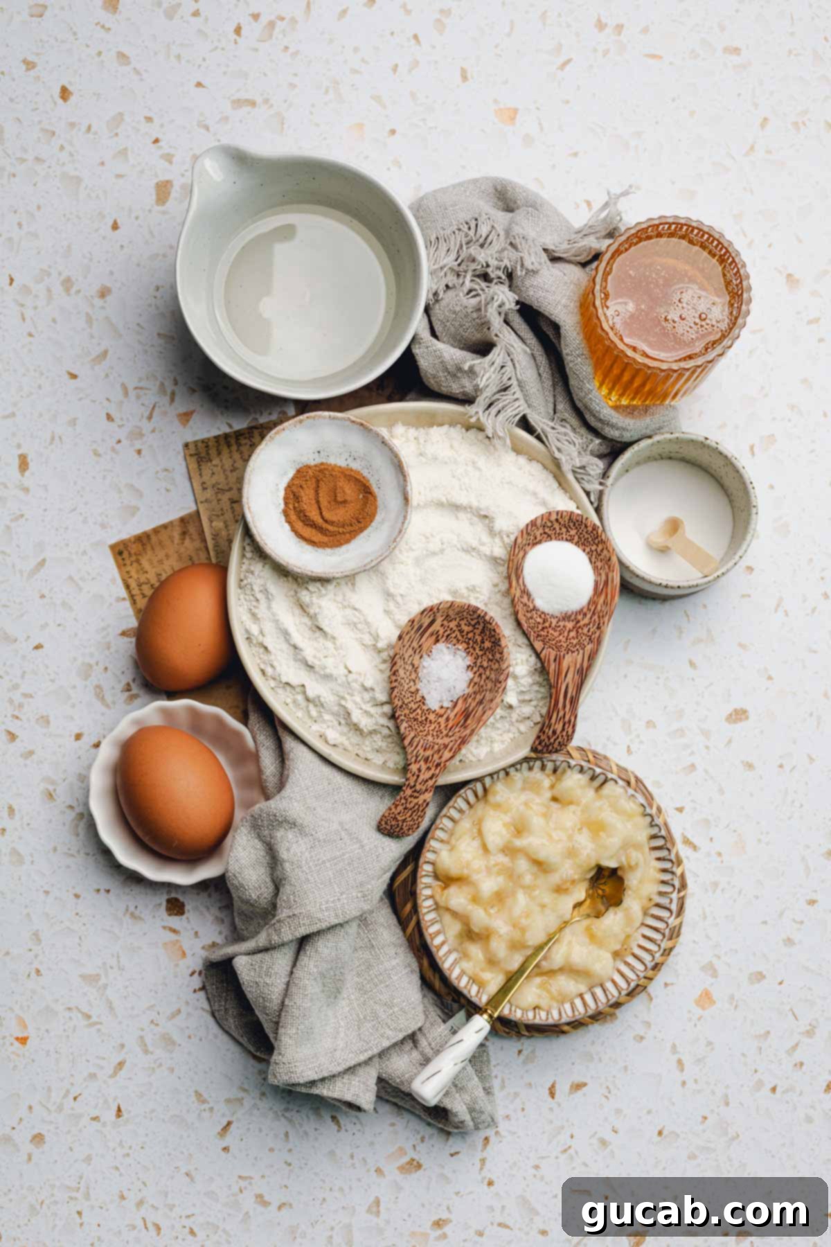 Ingredients for honey banana bread: coconut oil, honey, cinnamon, flour, baking powder, baking soda, salt, and mashed ripe bananas.