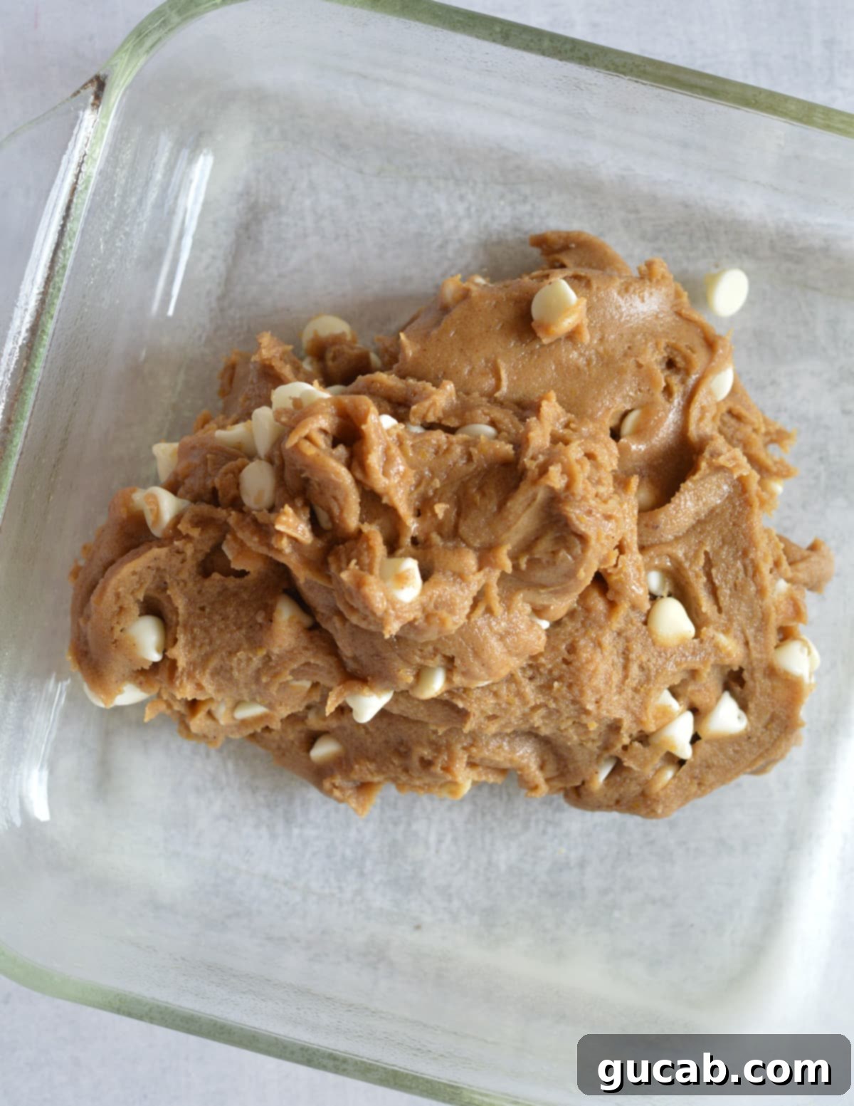 gluten-free blondie dough in a glass baking dish.