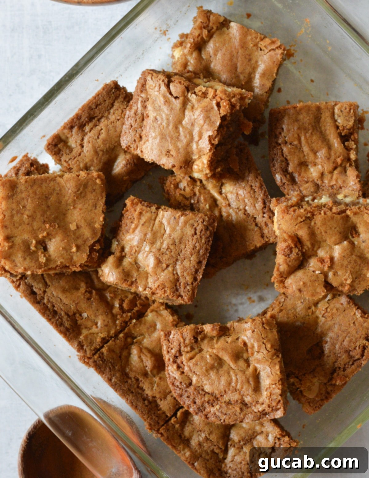 gluten-free blondies stacked on top of each other in a baking dish.
