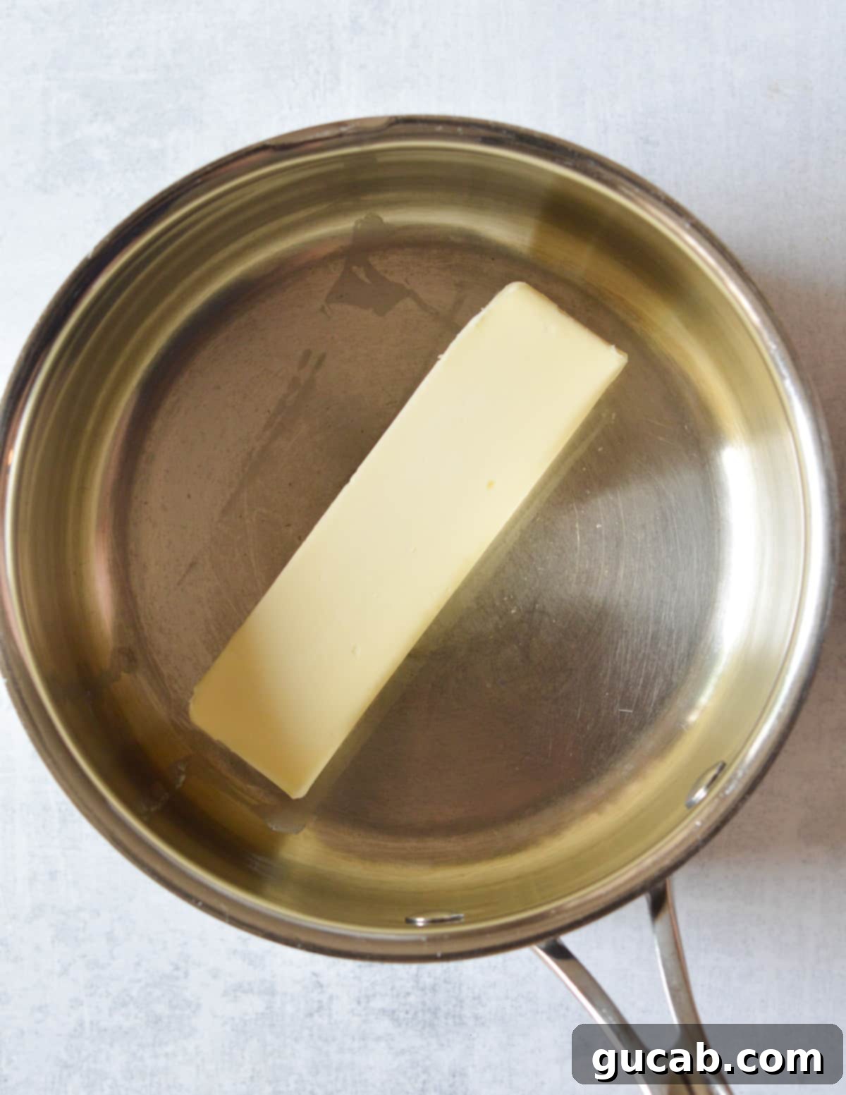 a stick of butter in a saucepan.
