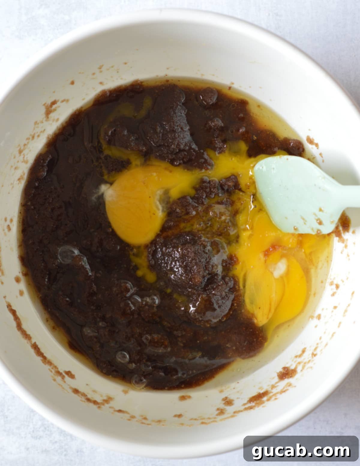 a bowl of browned butter and brown sugar mixed together with eggs on top.