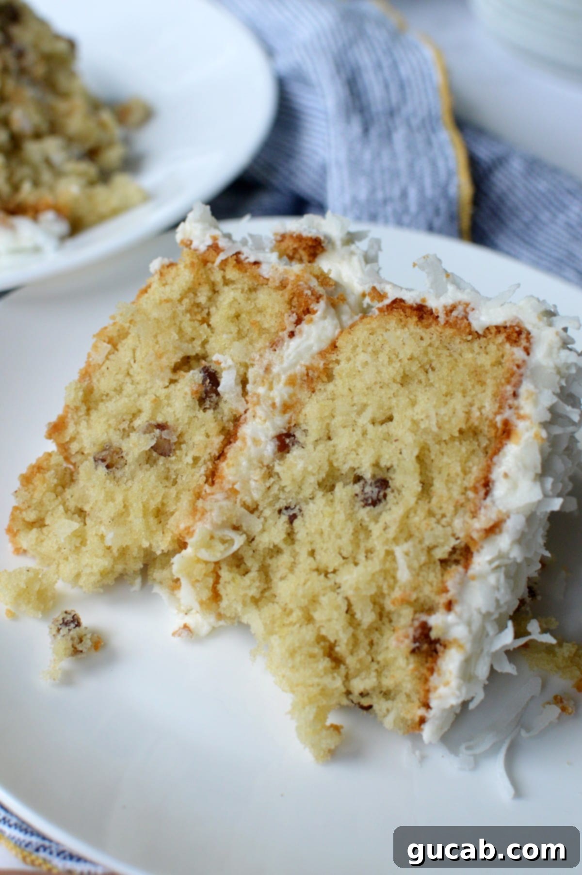 A beautifully frosted slice of gluten-free Italian cream cake, showcasing its moist texture and delightful layers