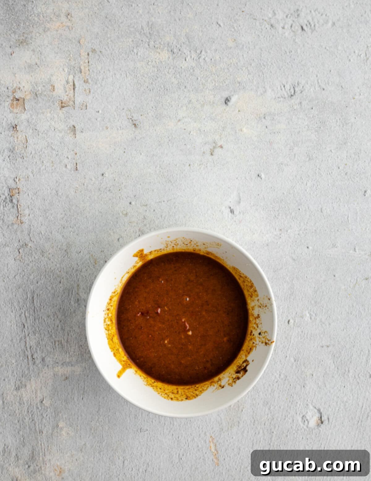 A vibrant, thick chipotle marinade in a glass bowl, ready for the chicken.